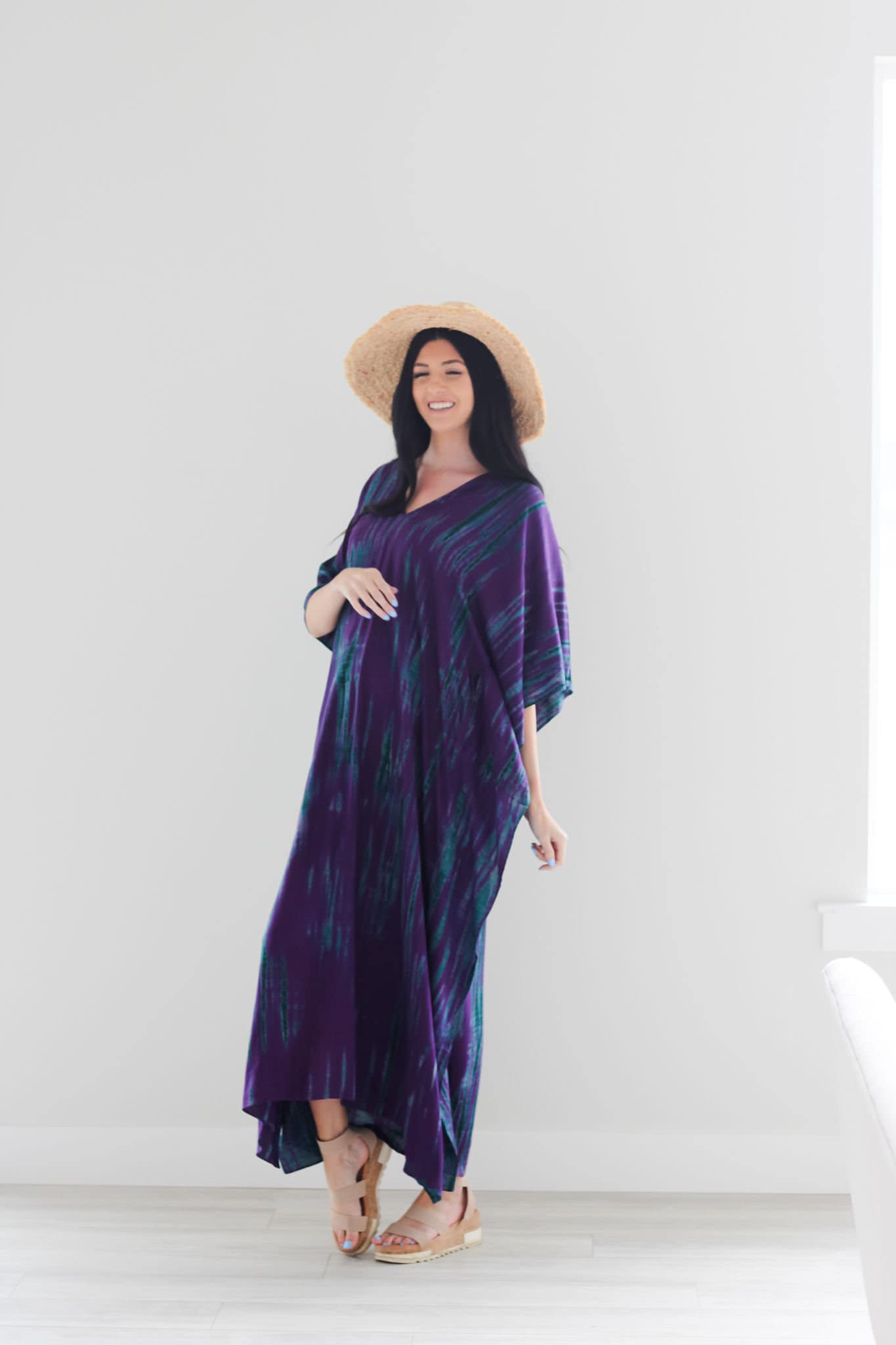 Purple tie-dyed maxi dress by Erin Pontus featuring a flowing kaftan style and long sleeves, perfect for elegant wear.