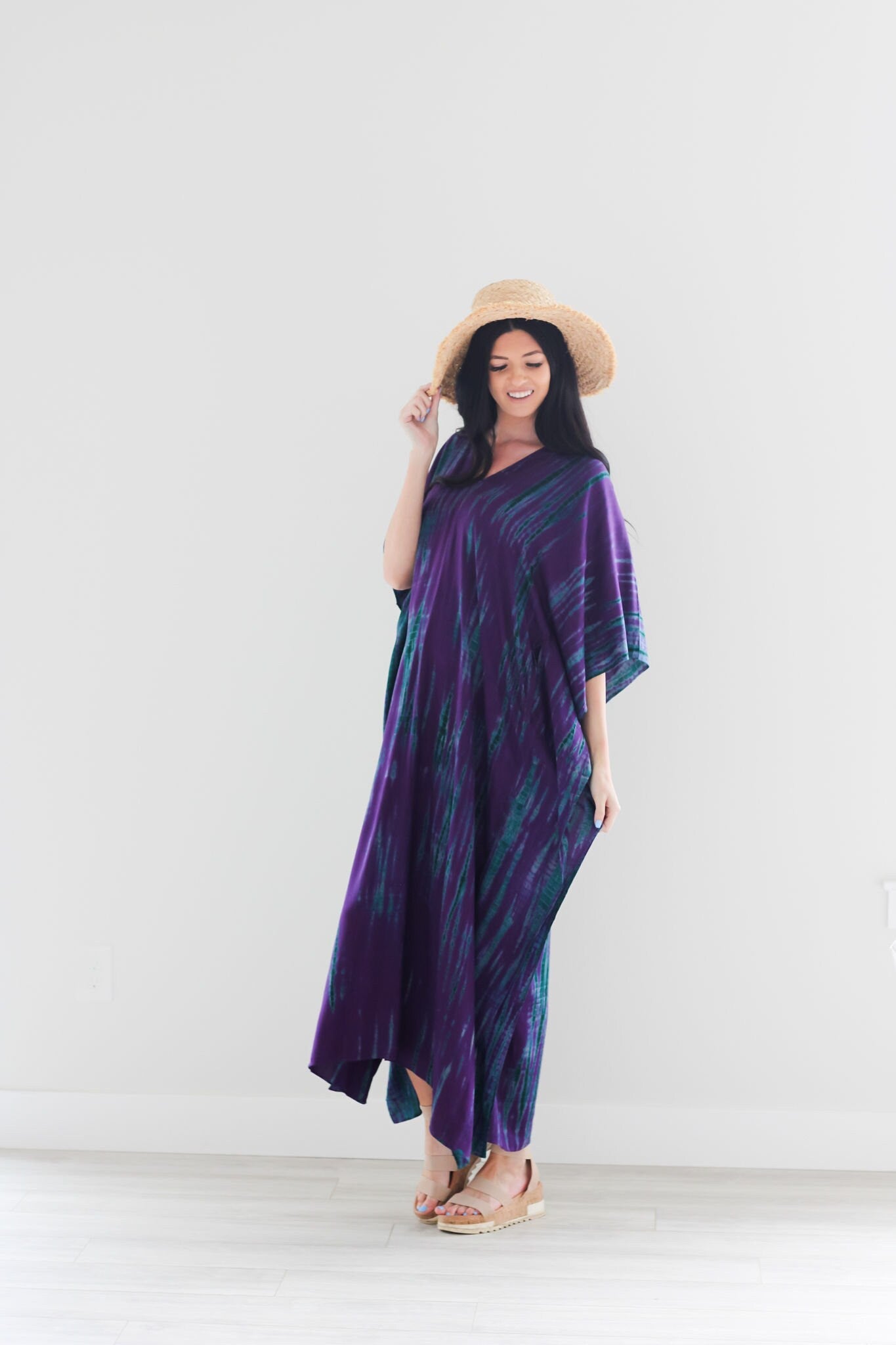 Purple tie-dye maxi kaftan dress by Erin Pontus, flowing abaya style with vibrant purple and unique dye pattern.