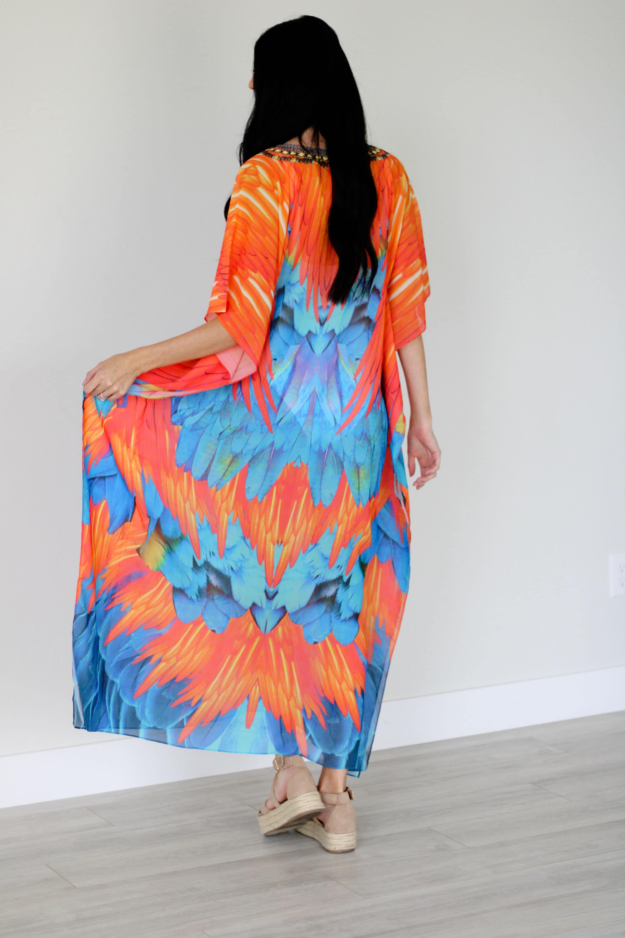 Plus size tribal feather kaftan dress by Erin Pontus, flowing fabric and vibrant patterns for a stylish, comfortable look.