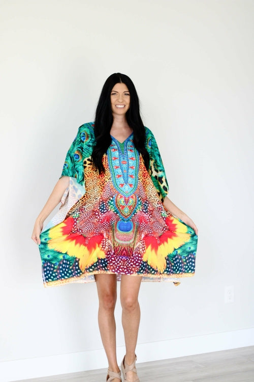 Plus size tropical kaftan dress by Erin Pontus featuring vibrant African-inspired patterns and a midi length style.
