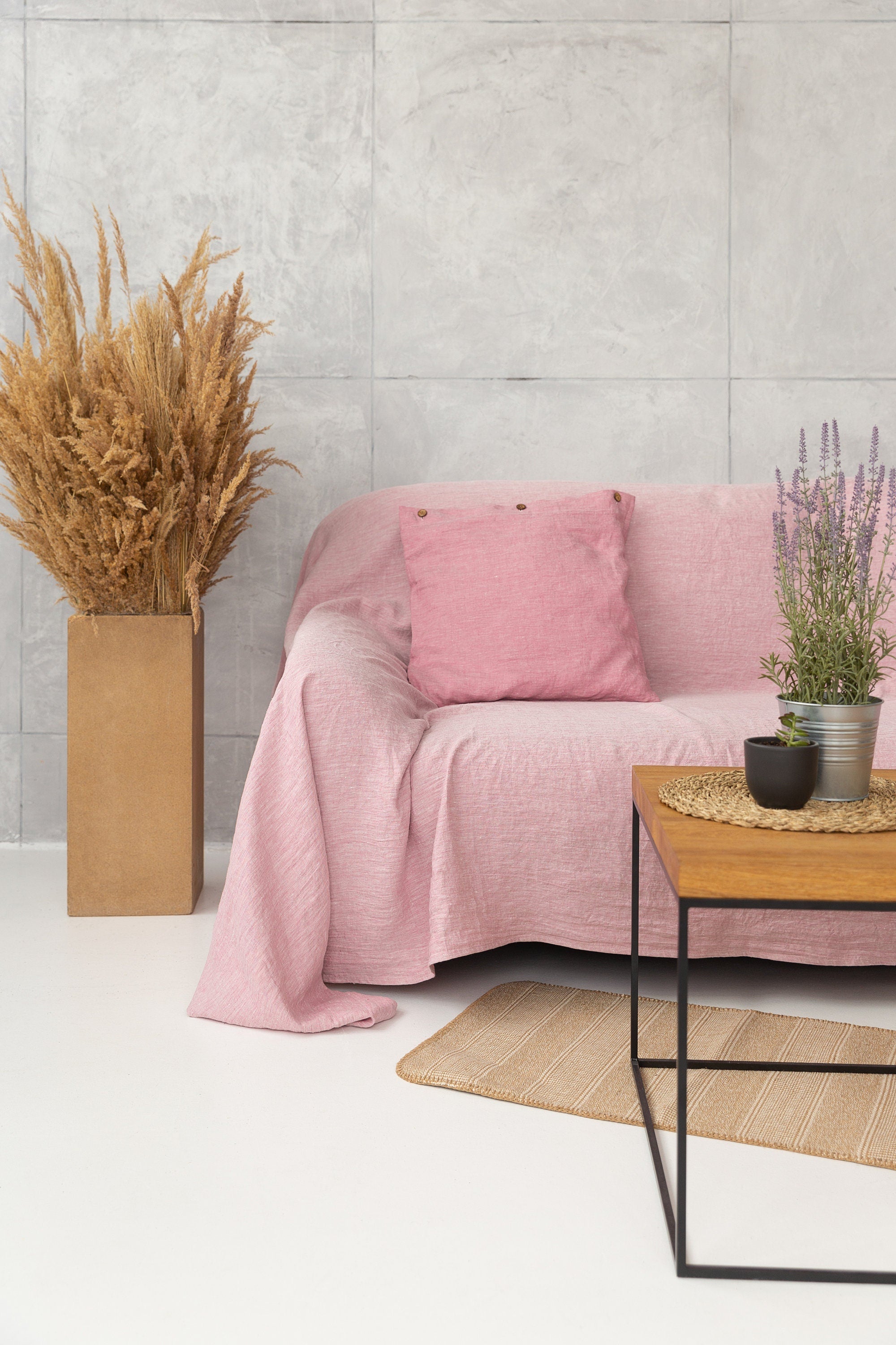 Magenta Sugarplum Woodrose linen couch cover draped over a sofa, showcasing elegant home decor with natural linen fabric.