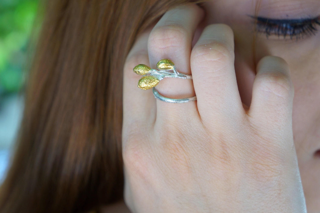 Handmade sterling silver adjustable leaf ring with olive branch design from Beige Briseis, showcasing detailed leaf and branch craftsmanship.