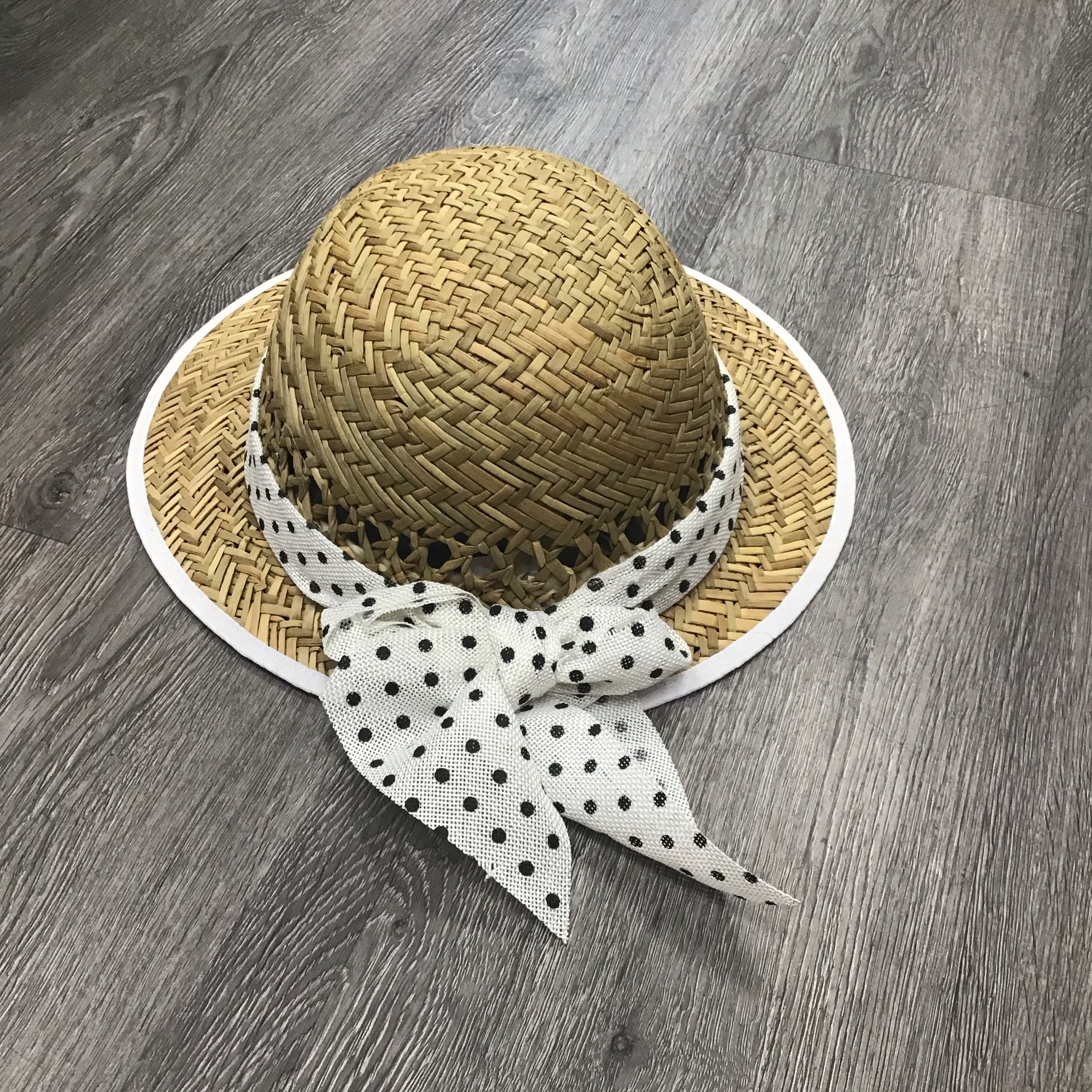 Violet Medea polka dot bow straw visor hat with wide brim and adjustable strap, perfect for sun protection and casual outdoor wear.
