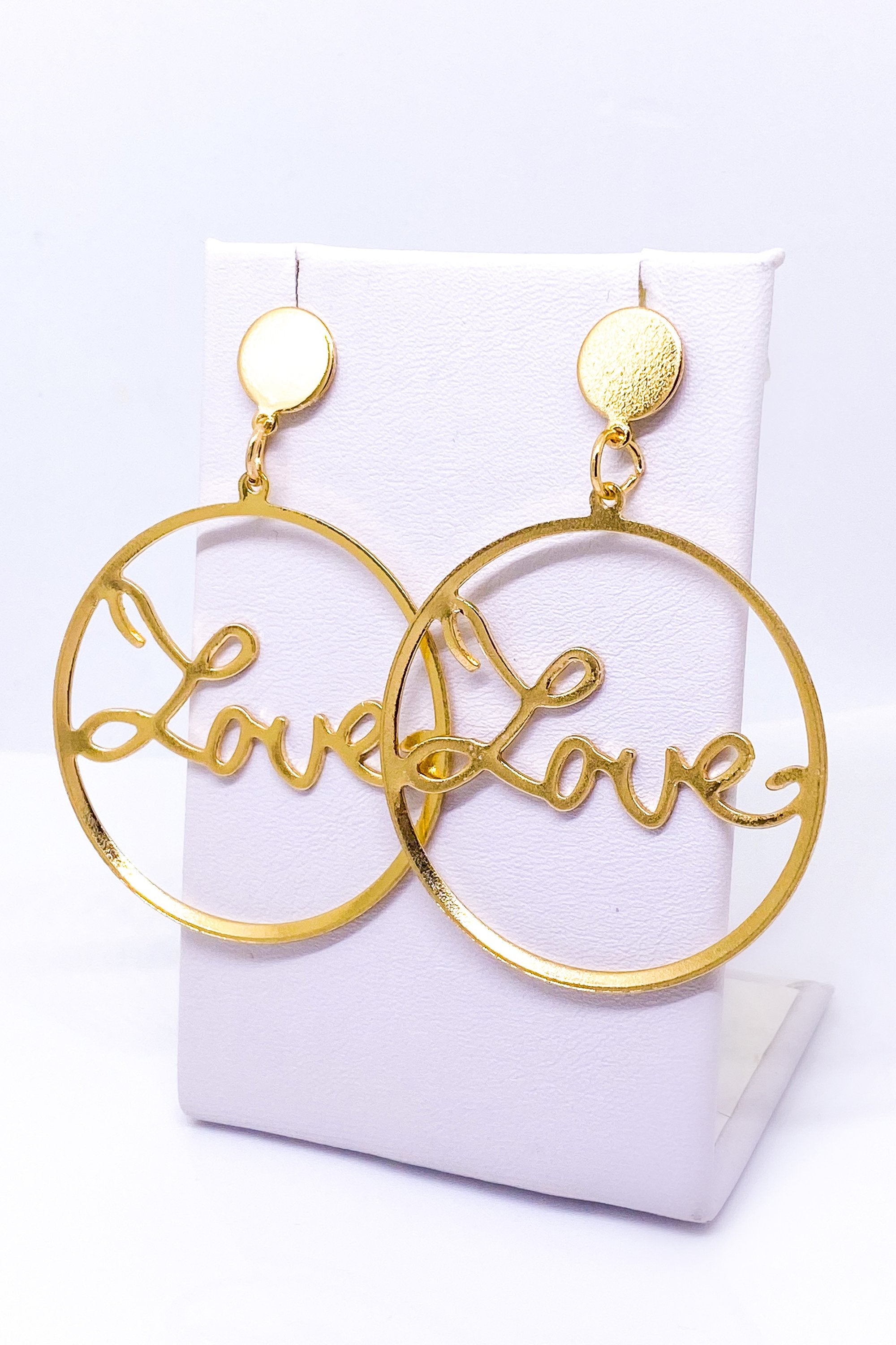 Burgundy Uranus Love Earrings with gold-tone hoops featuring heart-shaped charms, stylish and elegant jewelry for women.