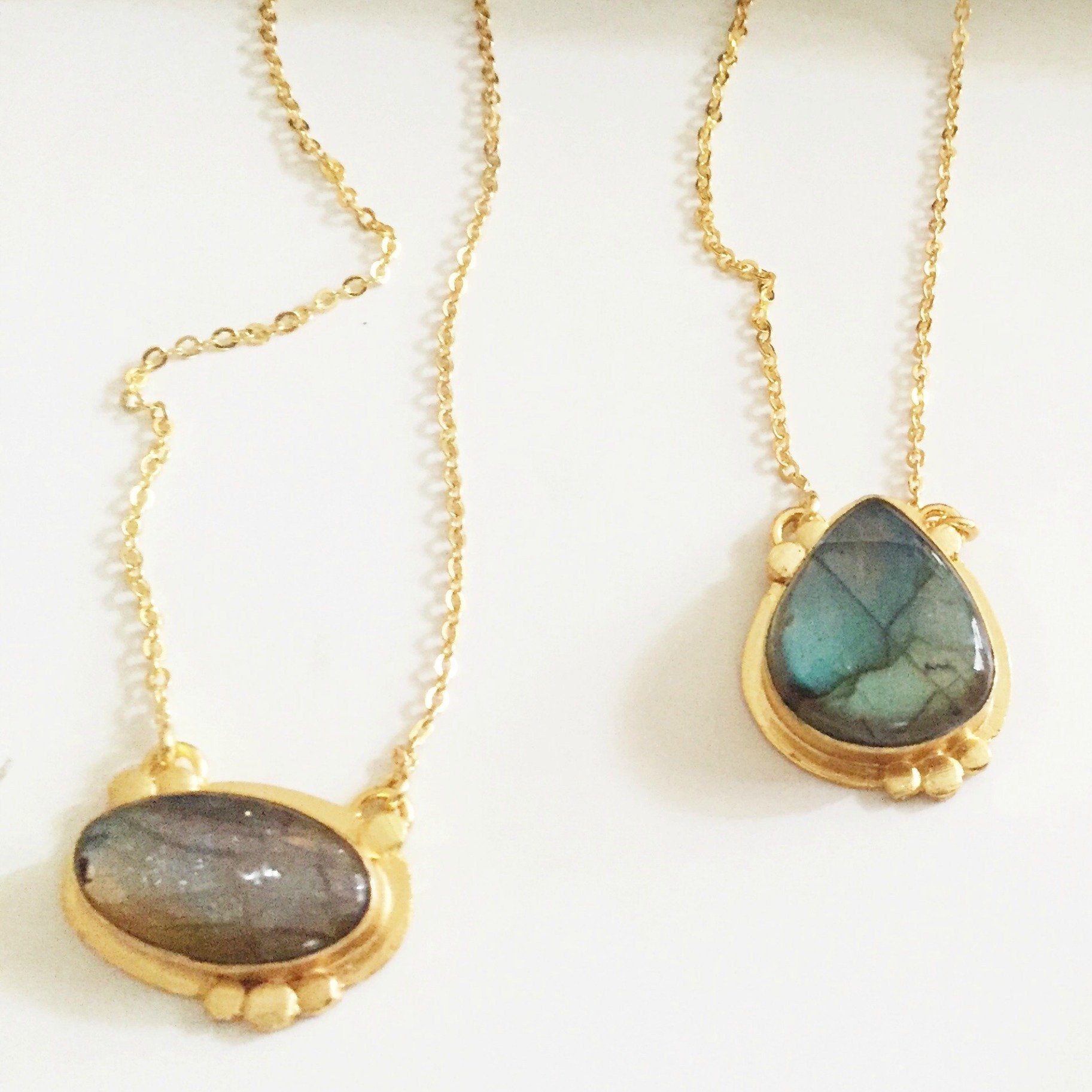 Violet Baobab Agadir Labradorite pendant featuring a polished blue-green labradorite gemstone on a silver chain.