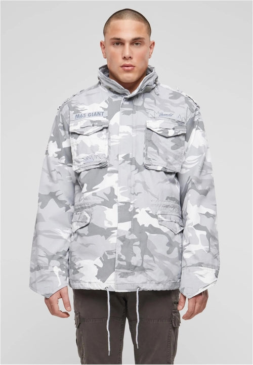 Callisto M65 Giant Heavy Jacket for men, featuring durable military-style design and heavy-duty fabric, shown in a rugged outdoor setting.