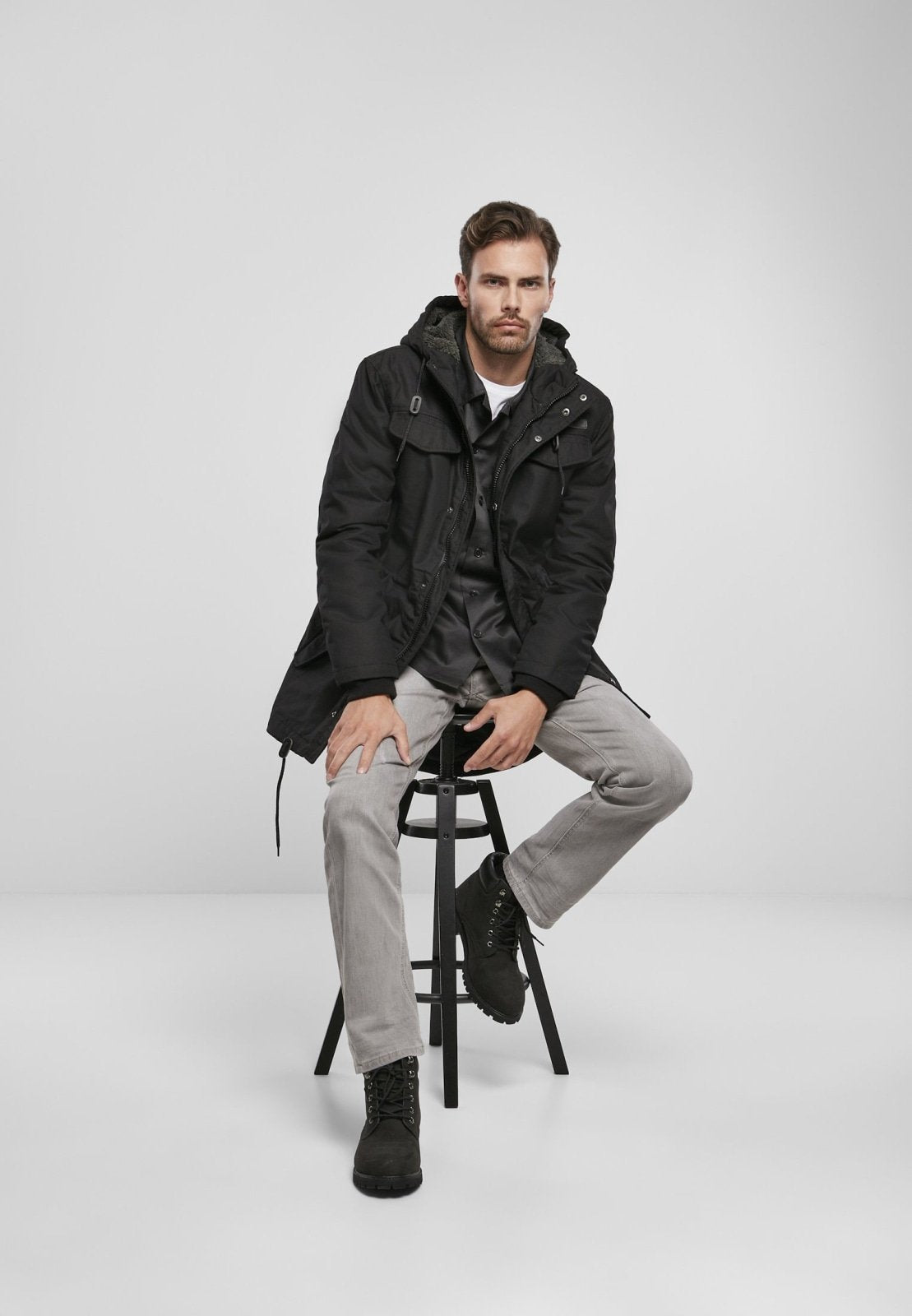 Callisto Marsh Lake Parka jacket with heavy fabric, shown in a natural outdoor setting, featuring a hood and insulated design.