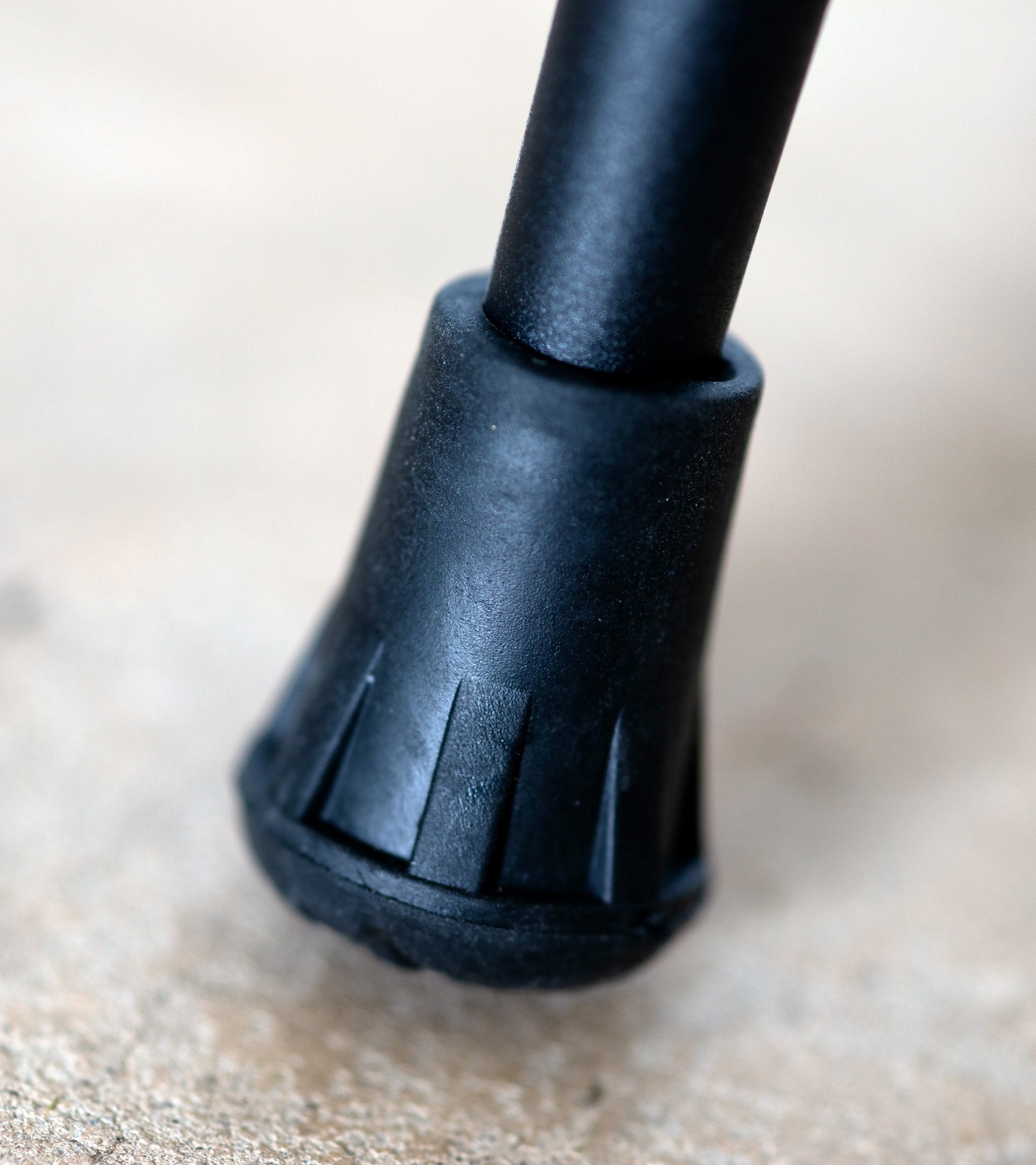Set of four Triangulum trekking poles rubber tips for hiking and camping, shown attached to trekking poles in outdoor setting.