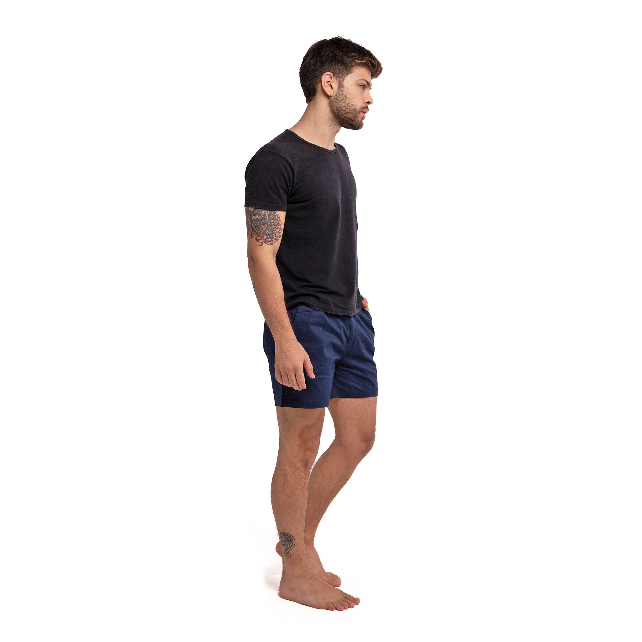 Navy cotton swim shorts by Ruby Tartarus with a relaxed fit, shown on a model against a neutral background.