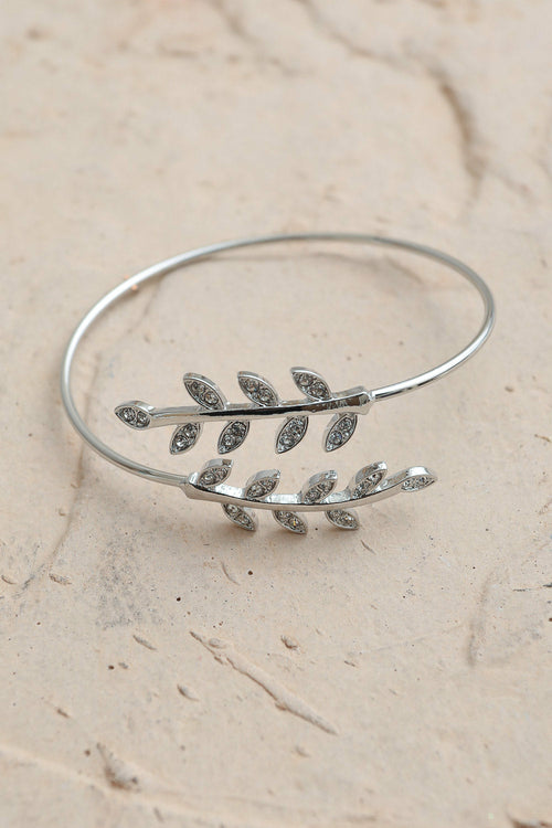 Silver Olive Branch Minimal Bracelet by Periwinkle Aether featuring a delicate olive branch design in a sleek, minimalist style.