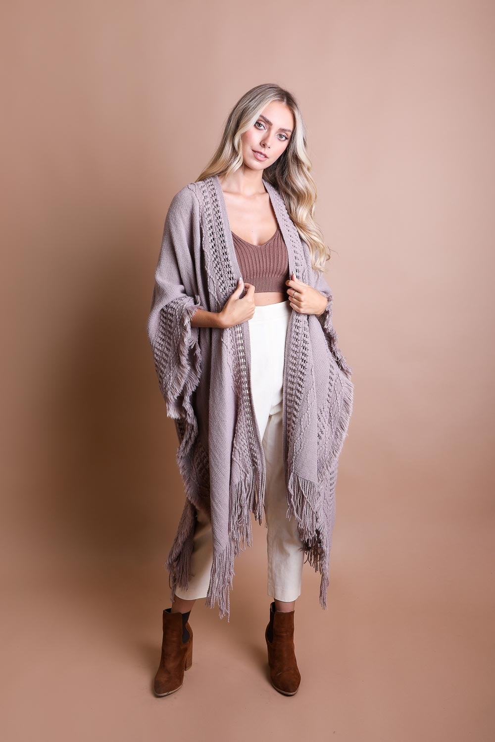 Open work bohemian ruana by Periwinkle Aether featuring frayed edges and intricate open-knit design, perfect for stylish layering.