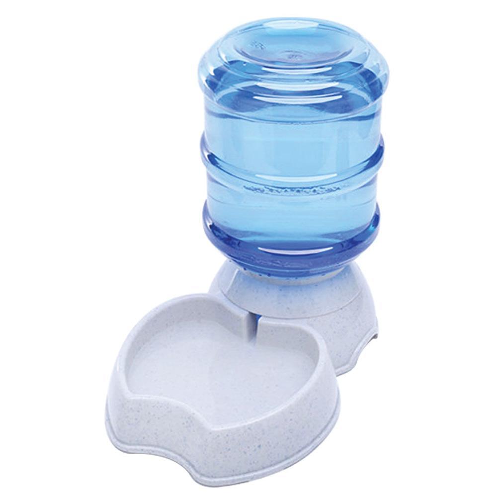 Ozdingo 3.8L pet water dispenser and automatic waterer for dogs and cats with a bowl and water bottle in a home pet supplies setting.