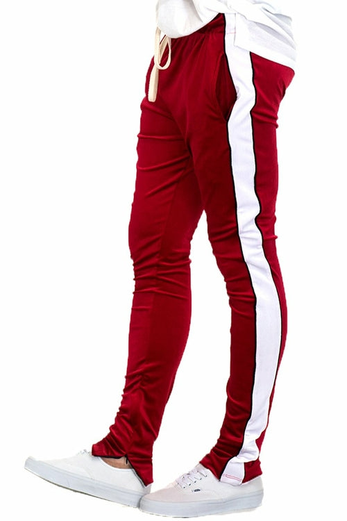 Lime Milo velvet pants with side stripe piping, ankle zippers, and jogger style, displayed on a model.