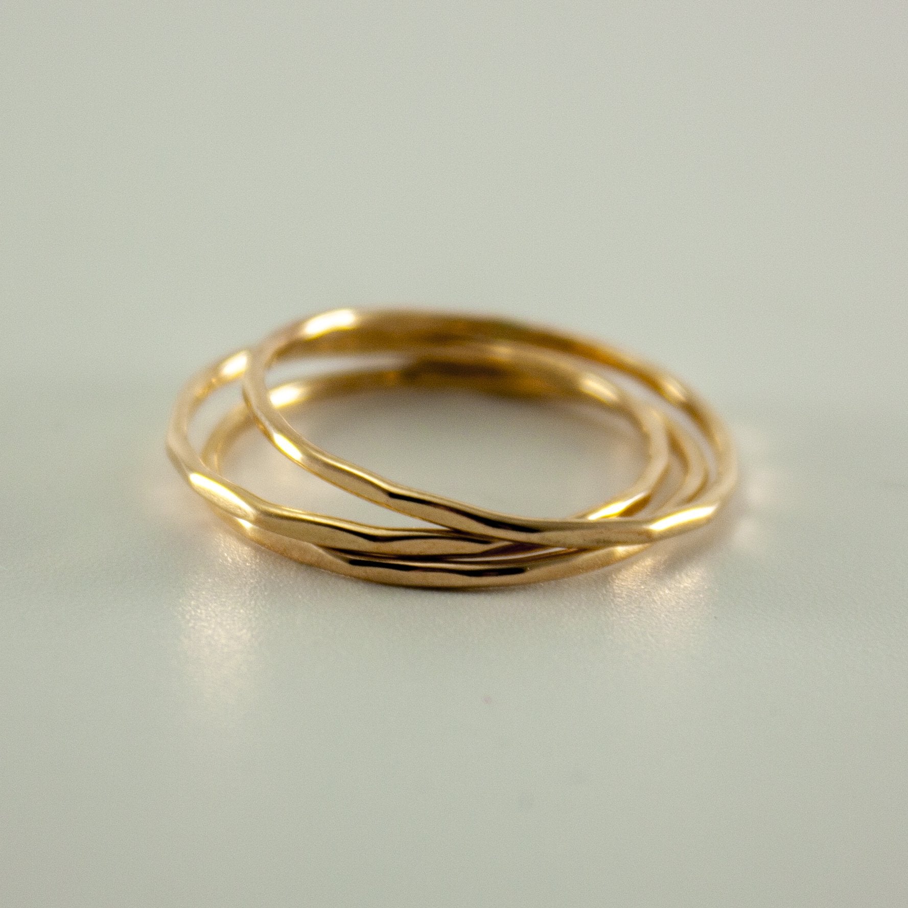 Hammered 14k gold filled slim ring stack by Grey Clymene featuring multiple stacked delicate gold bands