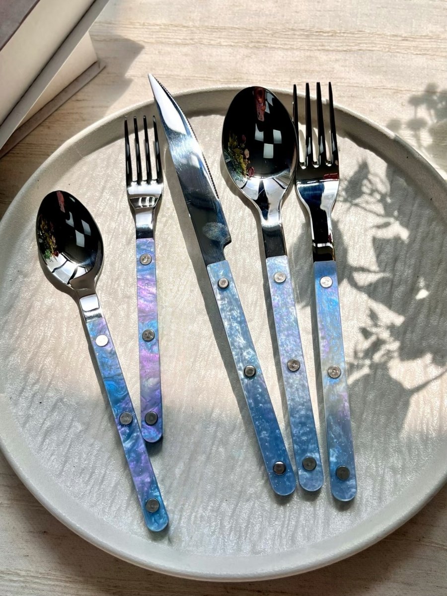 Set of 10 modern nebula bistrot style rivet flatware cutlery set for home decor, featuring sleek stainless steel utensils.