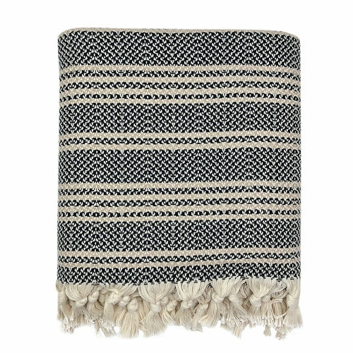 A woven Turkish throw blanket with black and white stripe design, ideal for home decor from Ariel.