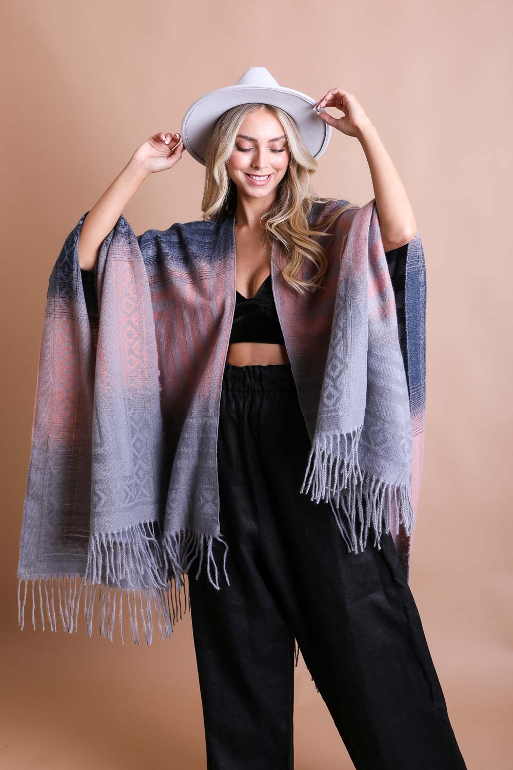 Colorful Western-style tassel serape accessory from Periwinkle Aether with vibrant color blends and decorative tassels.