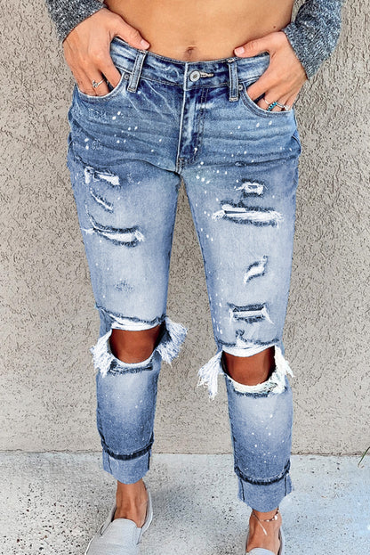 Light blue ripped straight leg jeans for women by Lavender Pallas, featuring distressed details and classic denim fit.