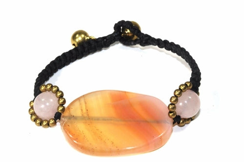 Silver Hestia Peach Agate Slice and Rose Quartz bracelet featuring polished stones and a delicate clasp on a neutral background.