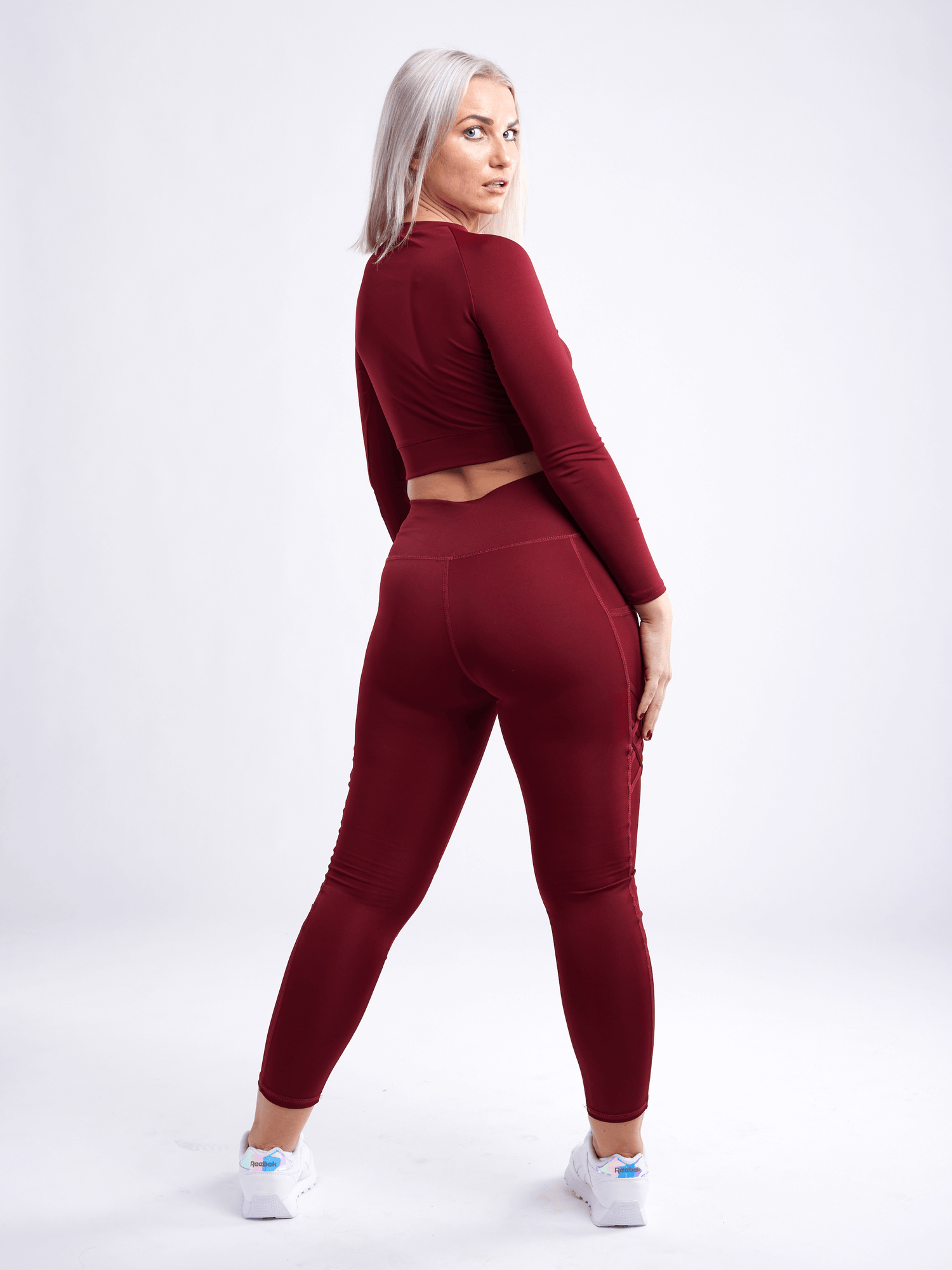 Black Lavender JupiterGear long-sleeve crop top, activewear for women, shown in black with fitted design and thumbholes.