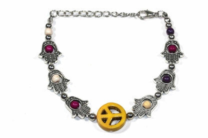 Silver Hestia Hamsa hands and peace bracelet with intricate design, featuring symbolic charms on a delicate silver band.