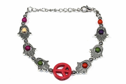 Silver Hestia Hamsa Hands and Peace bracelet with intricate charms, crafted in sterling silver, resting on a neutral background.