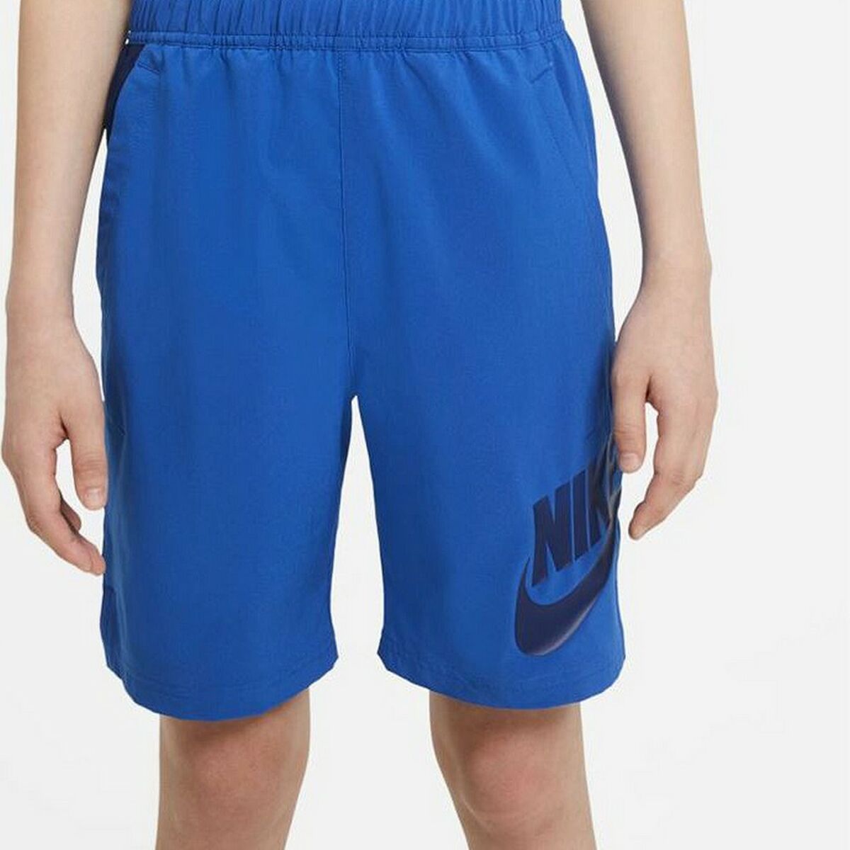 Kids Nike Sportswear sport shorts in blue with white Nike logo, designed for active outdoor play.