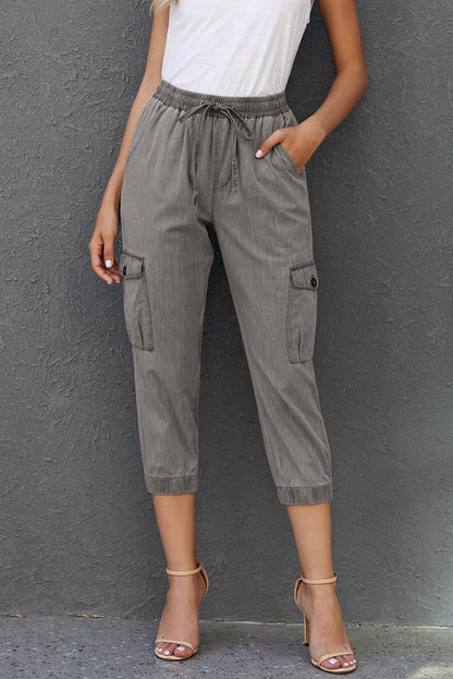 Gray drawstring cargo pocketed joggers for women by Lavender Pallas, featuring a relaxed fit and multiple side pockets.