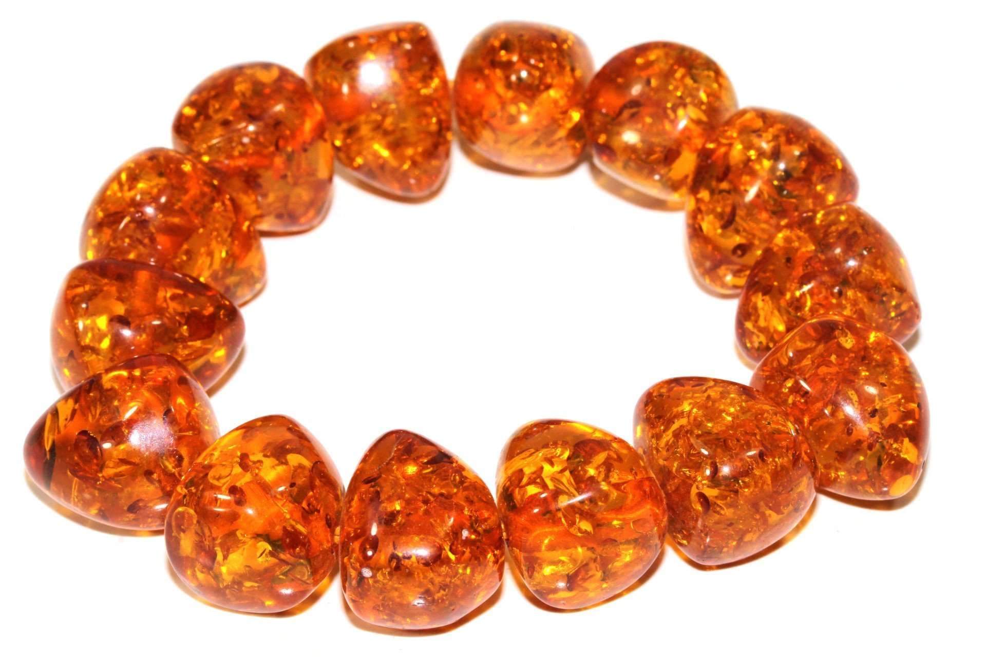 Silver Hestia Glowing Baltic Amber bracelet featuring polished amber beads and a delicate clasp on a neutral background.