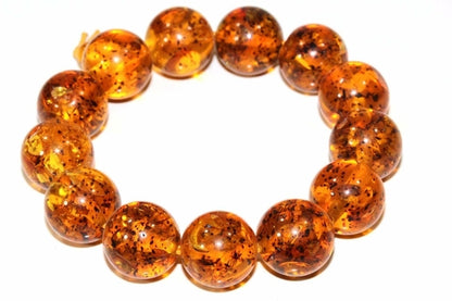 Silver Hestia Glowing Baltic Amber bracelet with polished amber beads and silver accents, displayed on a neutral background.