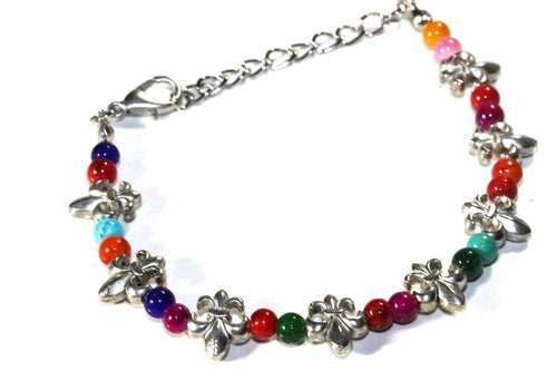 Colorful Fleur De Lis bracelet by Silver Hestia featuring vibrant beads and intricate metal charms on a multi-colored design.