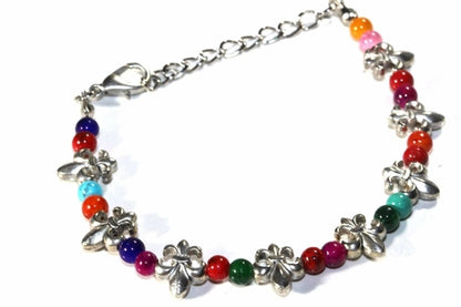 Colorful Fleur De Lis bracelet by Silver Hestia featuring vibrant beads and intricate metal charms on a multi-colored design.