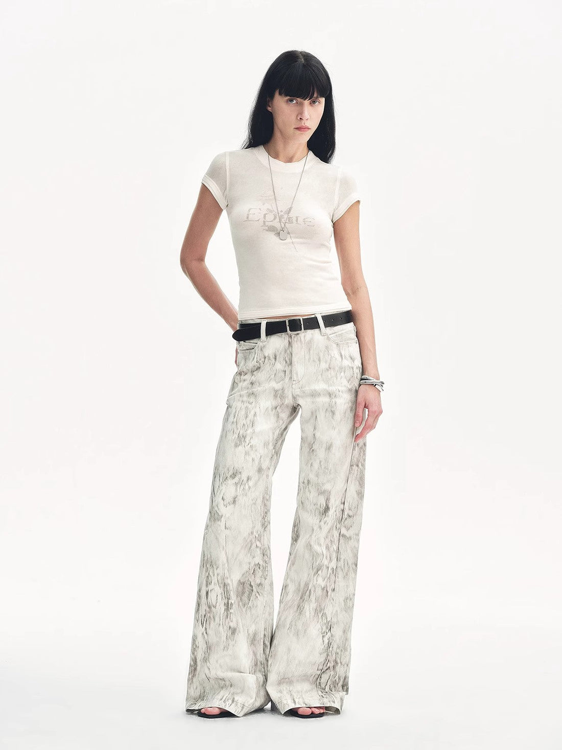 Brown Coeus "Phantom" snake print flared denim trousers, showcasing the stylish pattern and fit in a close-up image.