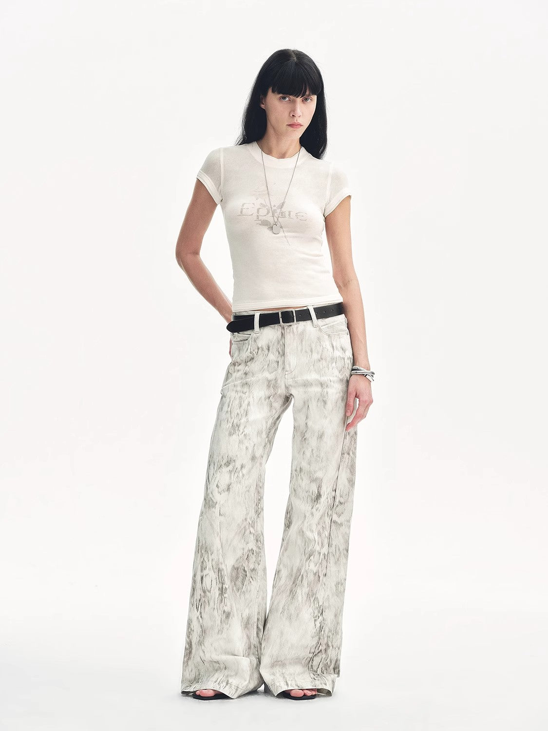 Brown Coeus "Phantom" snake print flared denim trousers, showcasing the stylish pattern and fit in a close-up image.