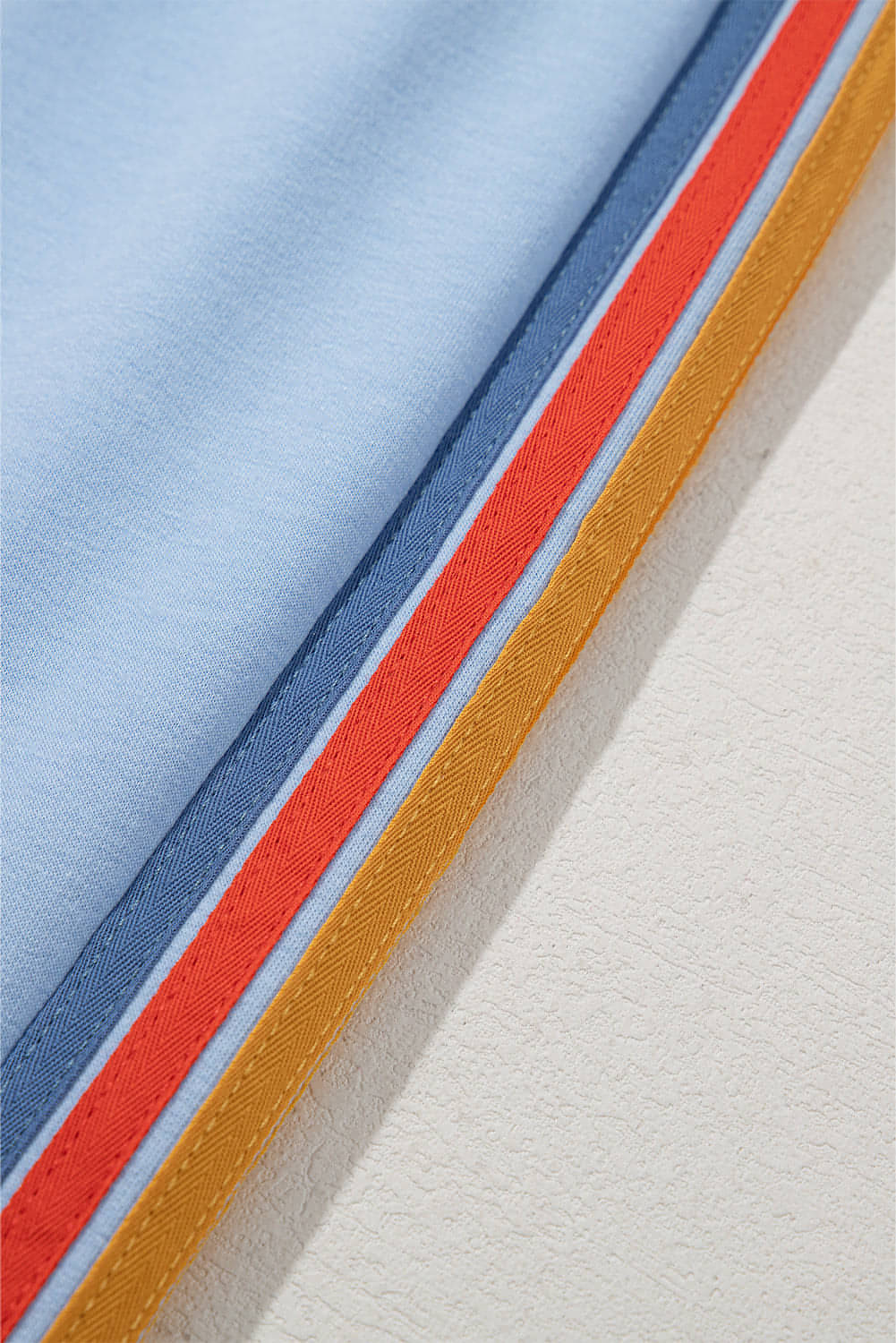 Light blue counting rainbows high waist sweatpants by Carmine Juneberry, featuring colorful rainbow print and comfortable fit.