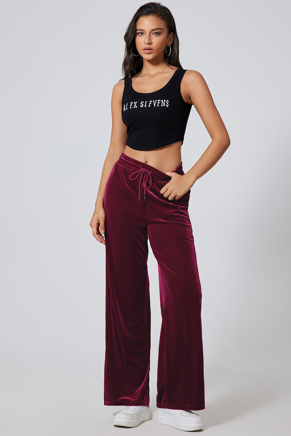 Carmine Juneberry burgundy wide-leg pants with drawstring waist, made from solid fabric, styled casually on a model.