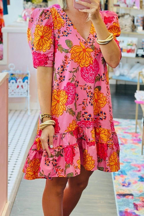 Pink floral bubble sleeve V-neck ruffled mini dress by Carmine Juneberry, featuring a feminine design with floral pattern and ruffle details.