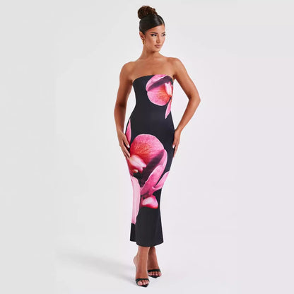 Carmine Juneberry 25 Edition backless floral draped tube maxi dress with a flowing silhouette and vibrant floral pattern.