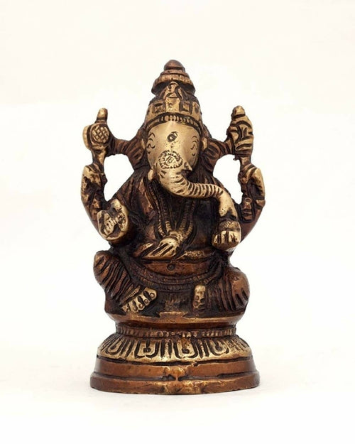 Alabaster Ganesha statue sitting on lotus flower, 5-inch sacred home decor sculpture for spiritual space and meditation.