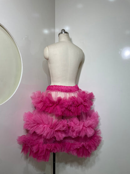 Pink tiered skirt for women from Champagne Pontus, featuring layered fabric and a stylish, feminine design.
