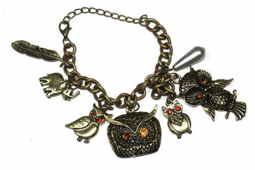 Silver Hestia bracelet featuring owl, elephant, and feather charms with delicate chain and intricate detailing.