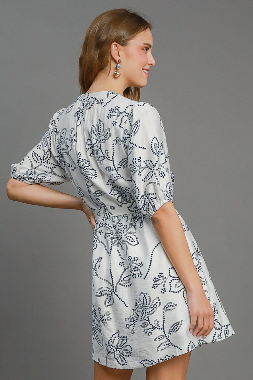 Automotive part from Jade Icarus featuring a floral print design, notched puff sleeves, and a mini dress style in plus size.