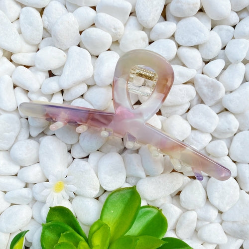 Fuchsia Hercules Barely There Hair Claw jewelry accessory with sleek design, shown holding hair in a close-up view.