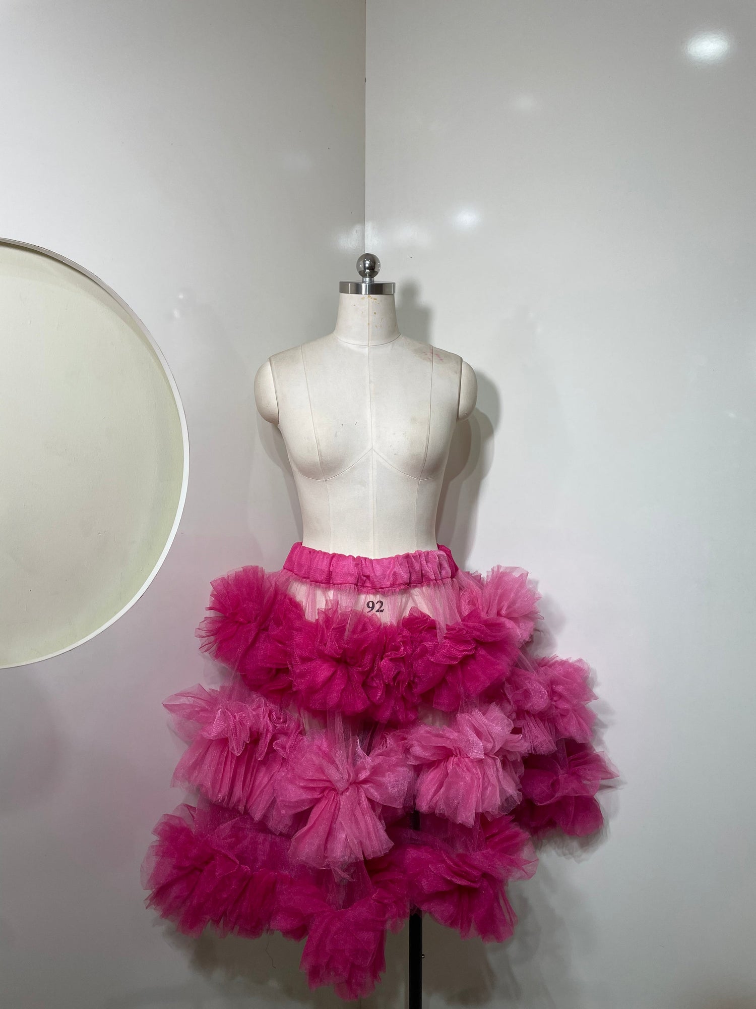 Pink tiered skirt for women by Champagne Pontus, featuring layered fabric and a flowy, feminine style.