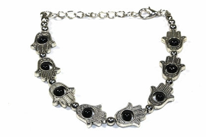 Silver Hestia Hamsa Hands and vibrant bead bracelet with colorful stones, showcasing intricate design and detailed craftsmanship.