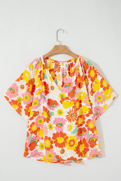 Orange abstract print V-neck blouse with half sleeves from Carmine Juneberry, stylish tops and blouses for casual or work wear.
