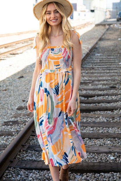 Multicolor shoulder tie smocked ruffle lined maxi dress for women by Ochre Ismene, featuring vibrant patterns and flowing fabric.