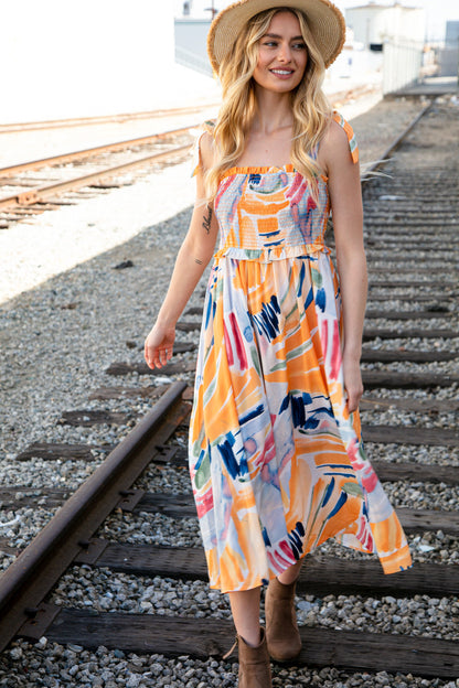 Multicolor shoulder tie smocked ruffle lined maxi dress for women by Ochre Ismene, featuring vibrant colors and flowing fabric.