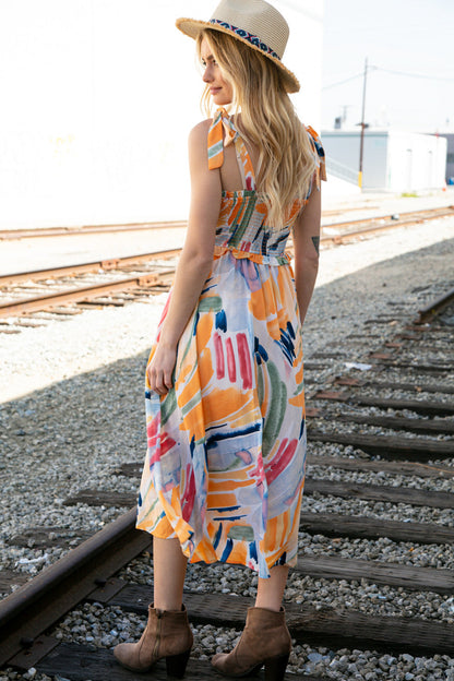 Multicolor shoulder tie smocked ruffle lined maxi dress for women by Ochre Ismene, featuring vibrant patterns and flowing fabric.