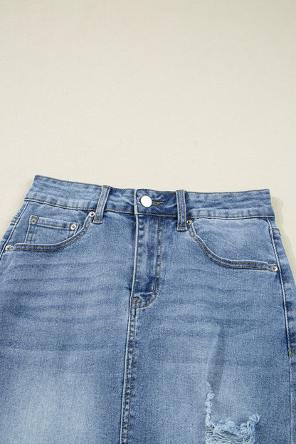 Women’s distressed denim midi skirt by Byzantium Bay featuring a casual fit and frayed hem, styled with pockets and belt loops.